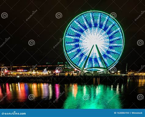 Reflection Of The Lights On The Ferris Wheel On The Coastline Of