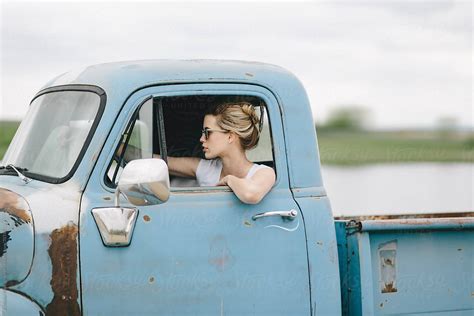 Blond Girl Driving An Old Pickup Truck By A Model Photographer