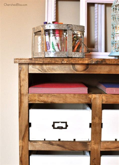 A Wooden Table Topped With Lots Of Drawers And Containers On Top Of