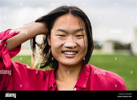 Happy Asian Woman Having Fun In A Park Stock Photo Alamy