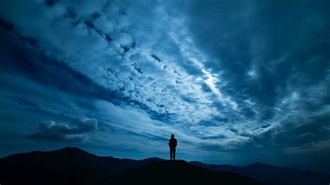 Where the honeybees are buzzing round the flowers there. The male standing on a night mountain with a cloud stream ...