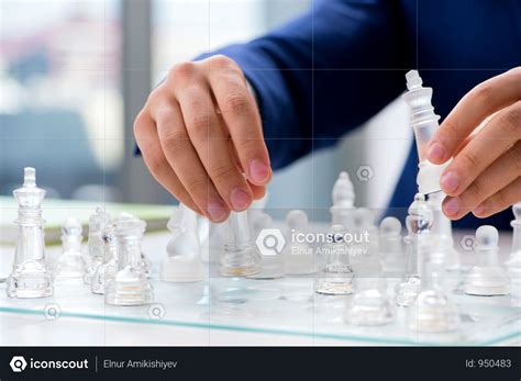 Young Businessman Playing Glass Chess In Office Photo Glass Chess