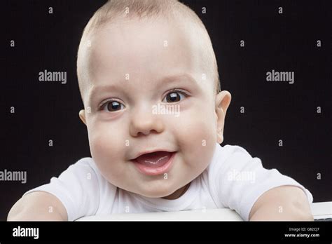 Portrait Of Happy Baby Boy Against Black Background Stock Photo Alamy