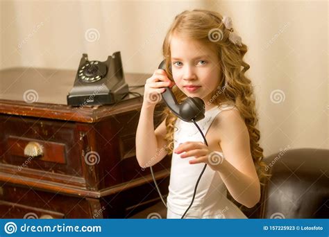 A Little Girl Is Ringing On The Old Phone Stock Image Image Of Child