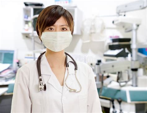 asian female doctor with surgical mask looking at camera in clinic lab stock image image of