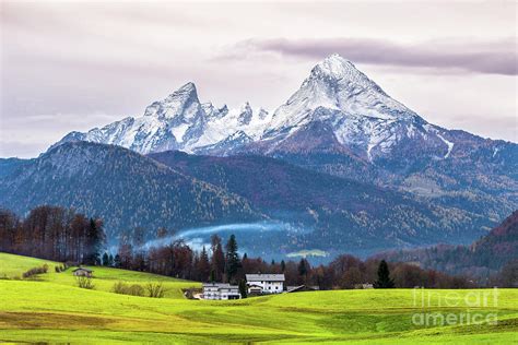 Green Meadow And Snow Capped Watzmann Mountain On A Background