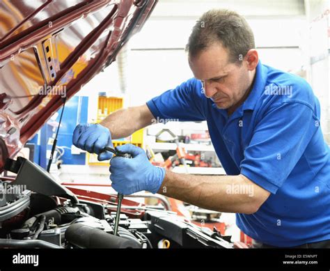 Mechanic Working On Car Engine Stock Photo Alamy