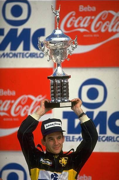 Ayrton Senna Of Brazil Holds The Trophy Aloft After His Victory In The