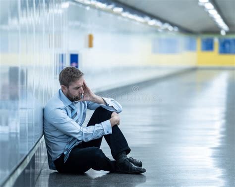 Young Jobless Business Man Suffering Depression Sitting On Ground