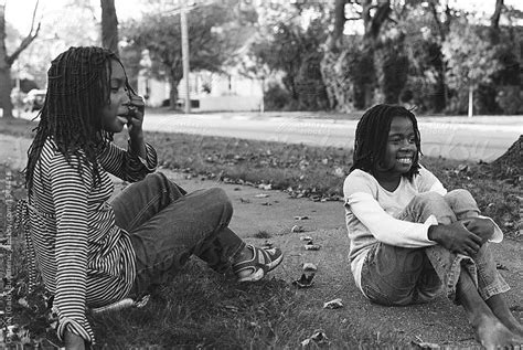 two black girls laughing on the sidewalk by gabriel gabi bucataru for stocksy united black