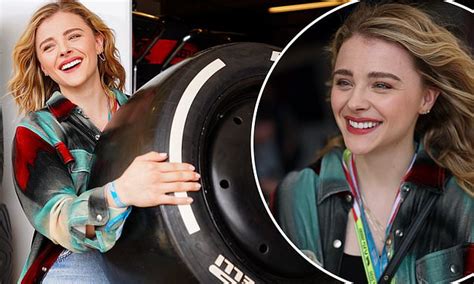 Chloe Grace Moretz Shows Off Her Strength As She Lifts A Wheel Outside The Formula 1 In Austin