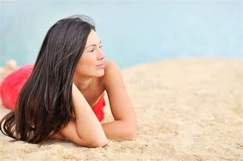 Beautiful Woman Lying On A Sand While Looking At Copyspace Stock Image