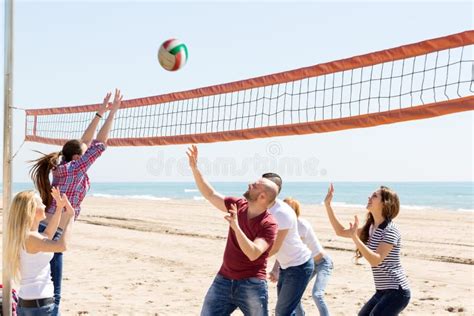 People Play Volleyball On Beach Stock Photo Image Of Cheerful