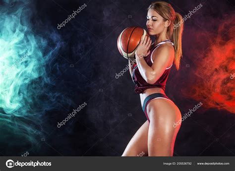 Beautiful And Sexy Fit Woman With A Basketball In Studio Sport Concept