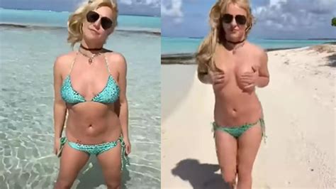Britney Spears Ditches Her Bikini Top On Beach In Her Latest Video On