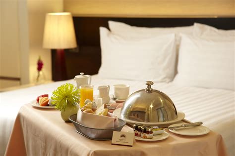 In room dining servers deliver food orders to hotel guests' rooms. Is Room Service Dead? - Chamberlin PR