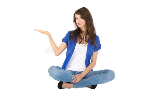 Isolated Young Woman Sitting In Crossed Legs Is Presenting Stock Photo