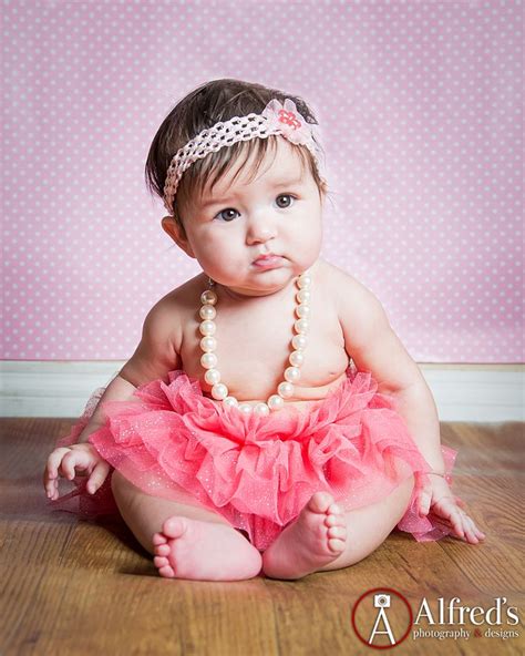 Baby Photoshoot Wearing A Pink Tutu And Pearls