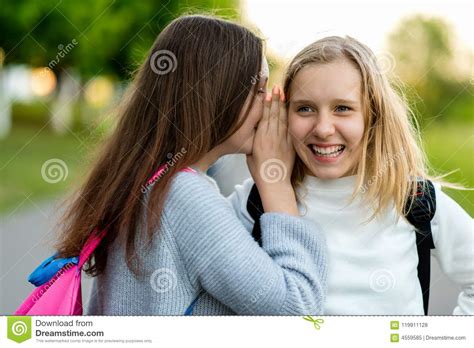 In Summer City Park Two Girl Friends Schoolgirls Teenagers Concept Of Joke Secret Fantasy