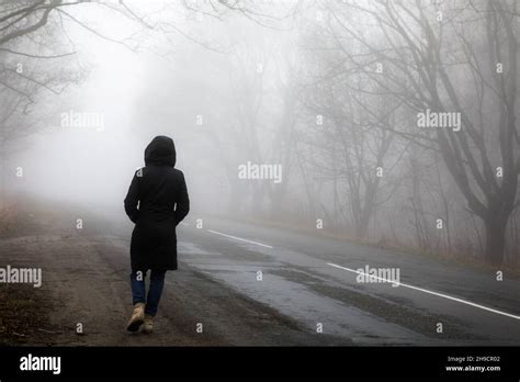 Fog Landscape Woman Walking Alone On Scary Foggy Misty Road Stock