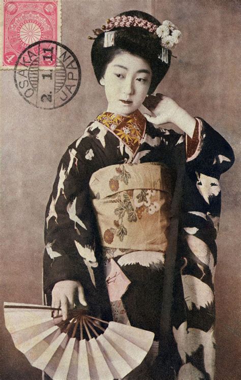An Old Photo Of A Woman In Traditional Japanese Dress Holding A Fan And