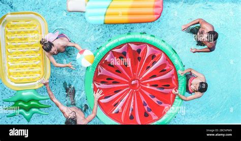 Happy Friends Playing With Air Lilo Ball Inside Swimming Pool Young