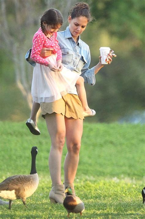 katie holmes grapples with a growing suri cruise as they feed the ducks at the park daily mail