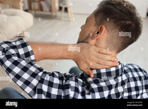 Man Suffering From Neck Pain Indoors Back View Stock Photo Alamy