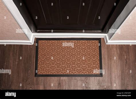 Blank Doormat Before The Dark Door In The Hall Top View Of Mat On Wooden Floor Mockup For Your