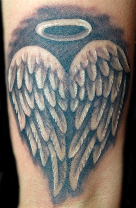 Wrist tattoo with angel wings. Remembrance Angel Wings Tattoo On Wrist - tattoo design