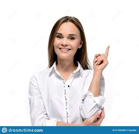 Smiling Young Woman Pointing A Finger At Something The Concept Of