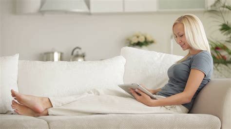 Pretty Girl Sitting On Couch Using Touchpad Stock Footage Sbv Storyblocks