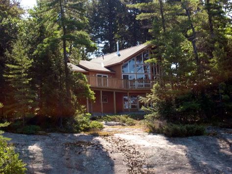 Built on lake rosseau, ontario, the tobin island boathouse stands between a forest and the serene surface of the water. Windermere and Lake Rosseau -- Ontario, Canada -- August 2003
