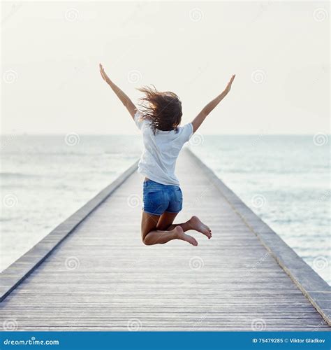 Back View Of Jumping Girl On The Pier Stock Image Image Of Movement