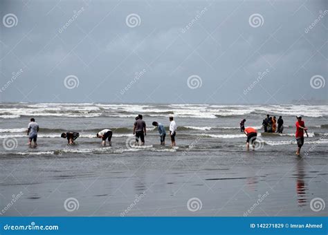 People And Families Wade In Water And Enjoy The Waves At Sea View Beach