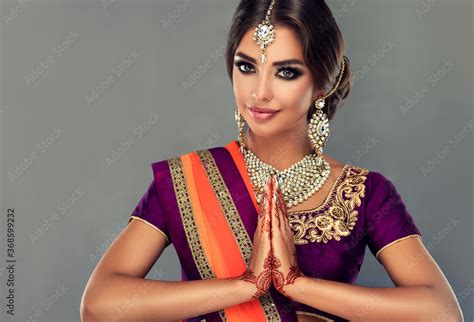 Portrait Of A Beautiful Indian Girl In A Greetting Pose To Namaste