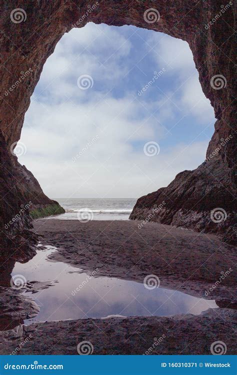 Vertical Shot Of A Carved Cave Window By The Water Stock Image Image