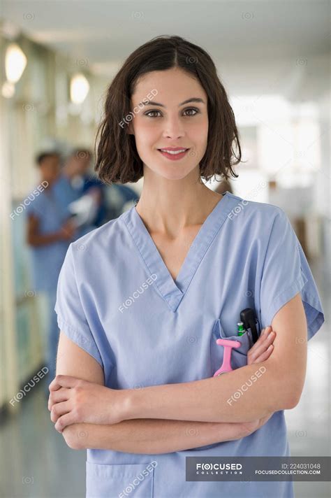 Portrait Of Smiling Female Nurse Standing With Arms Crossed — Caucasian