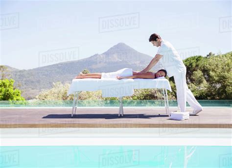Woman Receiving Massage At Poolside Stock Photo Dissolve