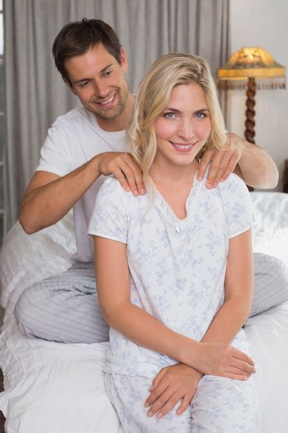 Premium Photo Man Massaging Womans Shoulders In Bed