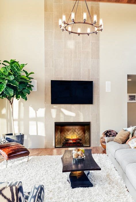 A large fireplace sits in the center of this pacific palisades living room, beneath a round mirror and surrounded by potted plants. Dimplex RBF42 Revillusion electric #fireplace -- latest ...