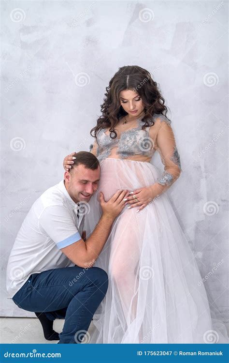 Pregnant Couple Man Kissing His Beautiful Wife In Belly Stock Image