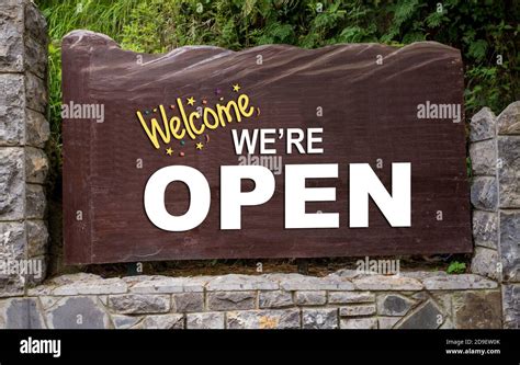 Welcome Back We Are Open Wood Sign Outside A Shop Stock Photo Alamy