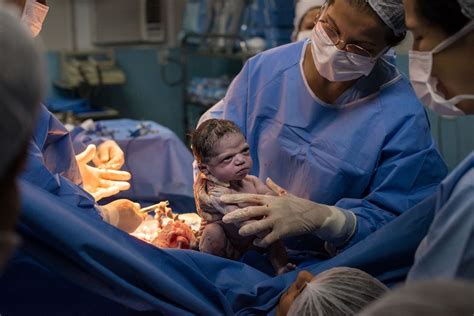 Grumpy Baby Displeased Newborn Stares Down Doctors Immediately After