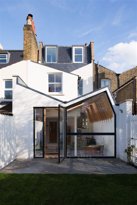 Magnificent white wooden ceiling column for butterfly roof via. A Renovation Reviving London's 'Butterfly Roof' | iGNANT.com