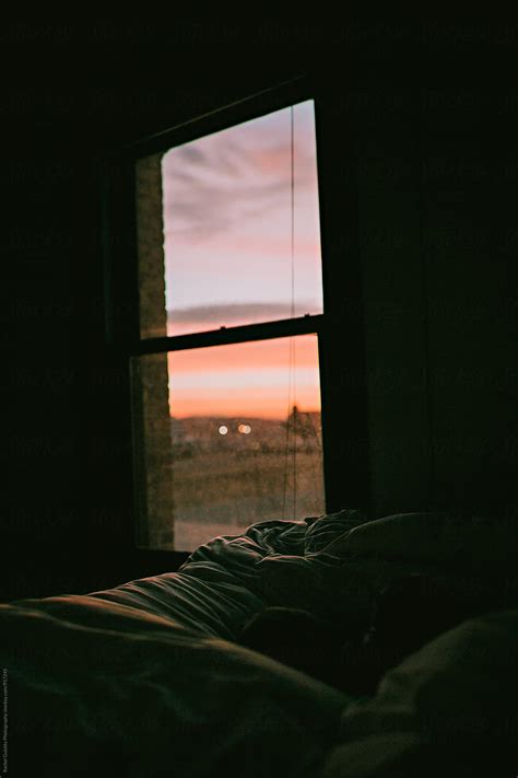 Sunrise Or Sunset Through An Apartment Bedroom Window By Mango Street