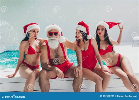 Photo Of Confident Serious Santa Claus Snow Maidens Wear Swimsuits Sun