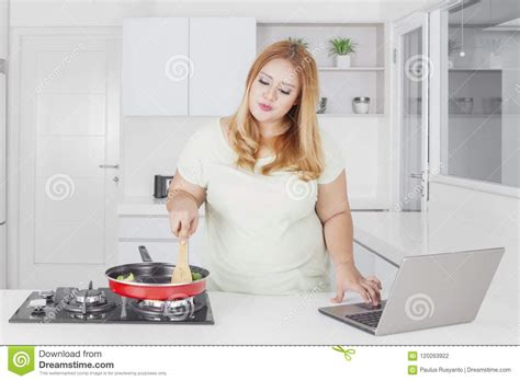 Caucasian Obese Woman With Laptop In Kitchen Stock Photo Image Of