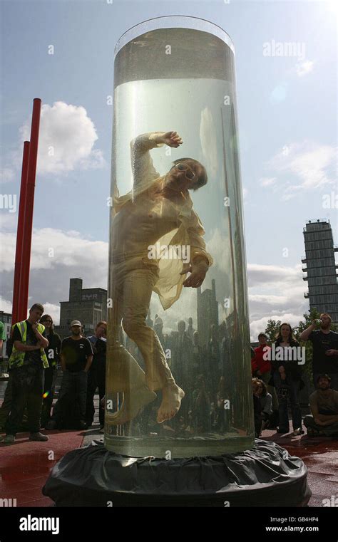 artist jorg muller stands inside a giant tube of water as part of an act called noustube during