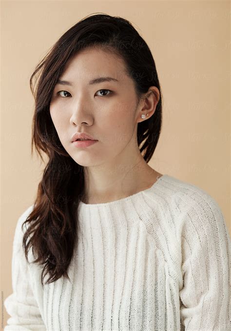 Portrait Of A Young Asian Woman With A Beige Background Del